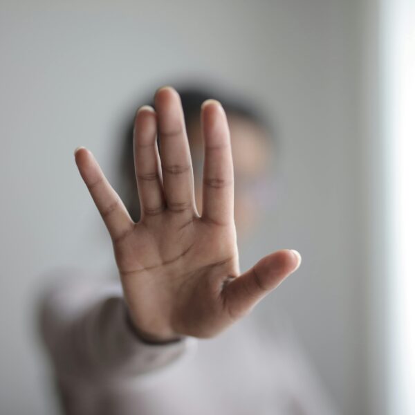 lady holding her hand towards camera. White background
